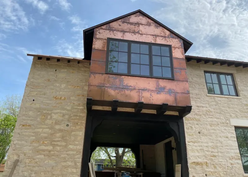 Copper metal panel facade on a stone building for Skylight Installation in Wapakoneta